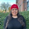 A woman with long dark hair wearing a Cardiomyopathy UK Beanie